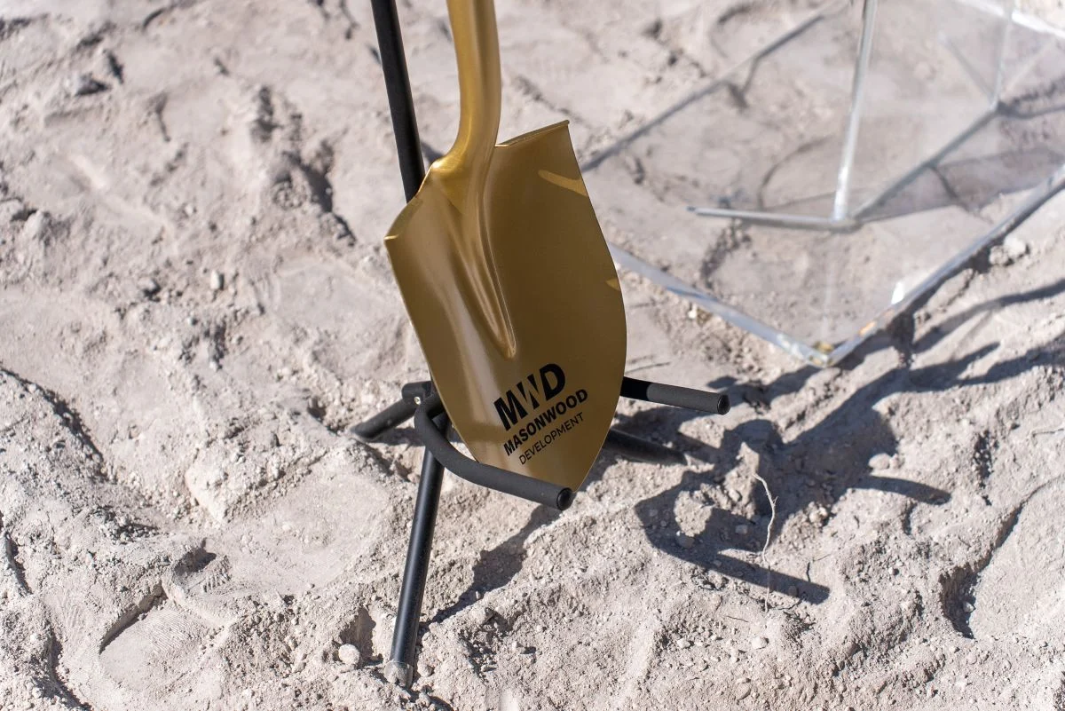 Close-up of a shovel featuring Masonwood Development branding at the groundbreaking event for Viana. 
